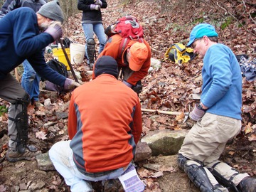 SATC Trailmaster Jeff Buehler instructs workers who are building a water bar to stop erosion on the AT